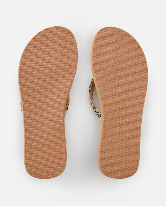 Rip Curl open toe flip flops with tan sole and patterned straps, viewed from the bottom