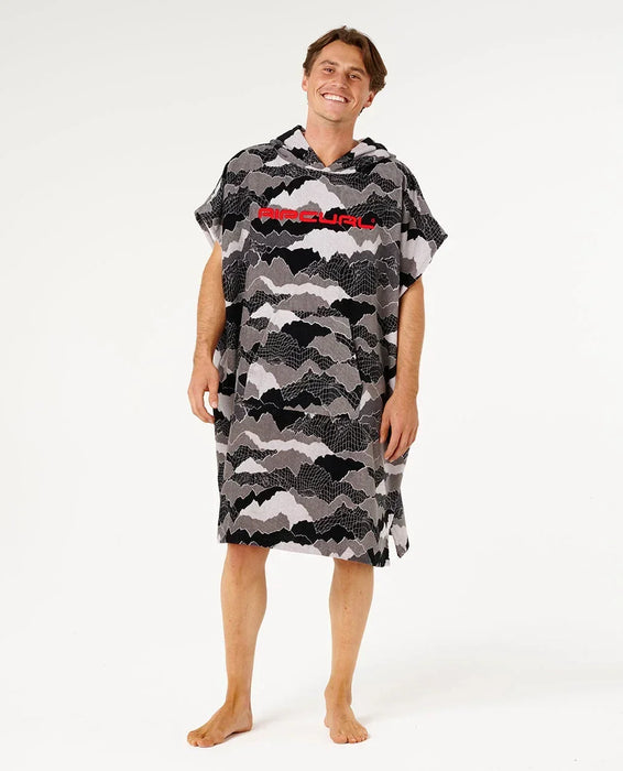Rip Curl hooded towel poncho in black and grey camo, worn by a man, ideal for watersports