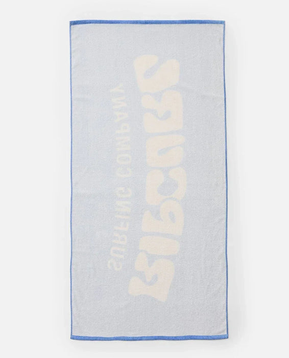 Rip Curl blue graphic beach towel with bold cream logo and blue trim, watersports accessory