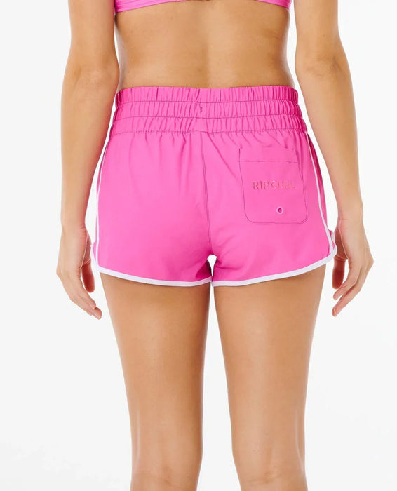 Rip Curl women's high waist retro boardshorts in bright pink with white trim, back view
