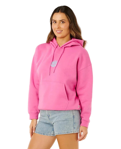 Rip Curl pink surf hoodie with front logo, worn by woman in denim shorts