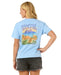 Rip Curl relaxed fit blue tee with floral and beach graphic, worn by woman in black shorts