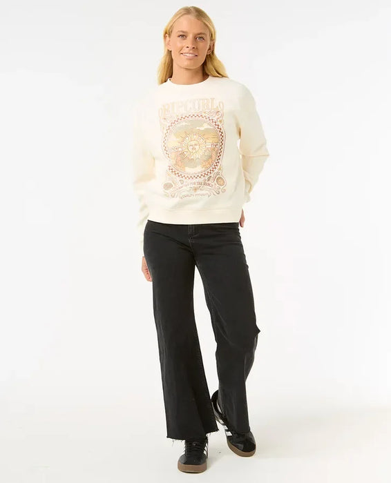 Woman wearing Rip Curl Luna relaxed crew sweatshirt in bone with graphic front, surf clothing