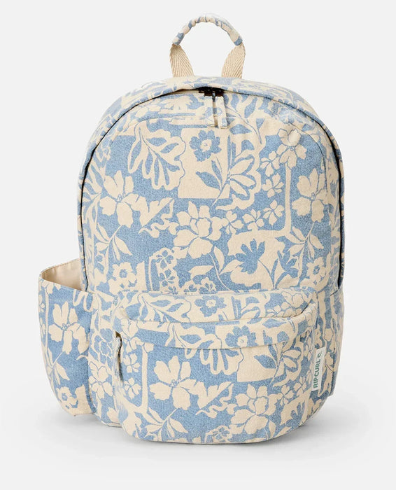 Rip Curl canvas backpack with blue and cream floral print, front pocket and side pouch
