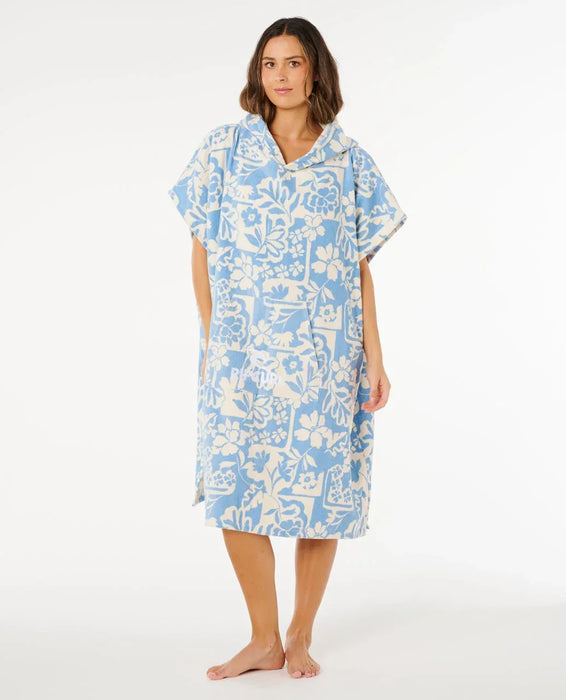 Rip Curl mixed hooded towel poncho in blissful blue with floral print, worn by a woman