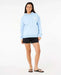 Rip Curl Shore Break Heritage light blue hoodie with white logo, worn by woman in casual beachwear