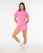 Rip Curl women's surf puff shorts and t-shirt set in bright pink, lifestyle photo