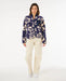 Rip Curl navy polar fleece jacket with cream floral print, worn by woman standing