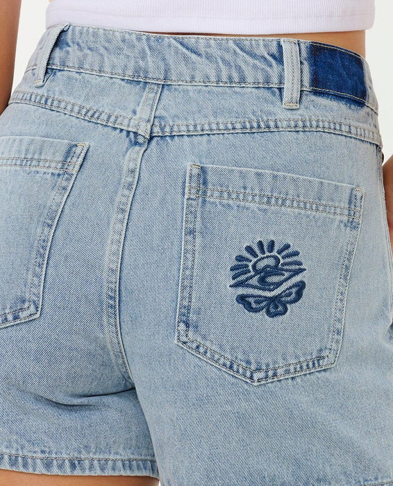 Rip Curl women's vintage blue denim shorts with embroidered sun and wave on back pocket