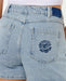 Rip Curl women's vintage blue denim shorts with embroidered sun and wave on back pocket