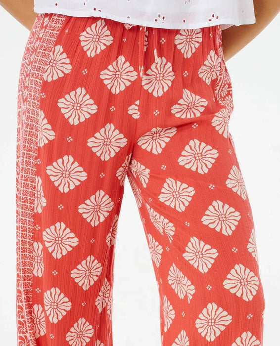 Rip Curl red wide leg pants with white floral pattern, surf clothing for women