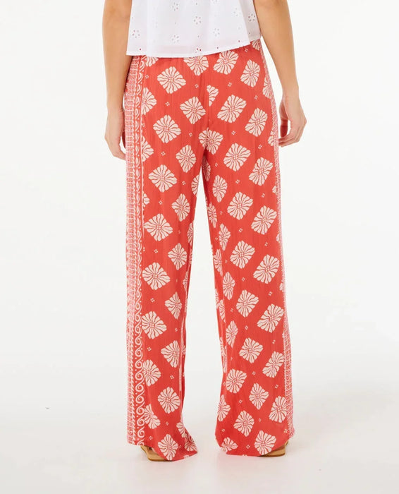 Rip Curl women's red wide leg pants with white floral print, back view