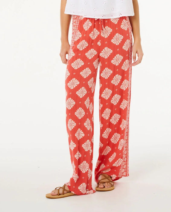 Rip Curl red wide leg beach pants with white floral pattern, relaxed fit, women's surf clothing