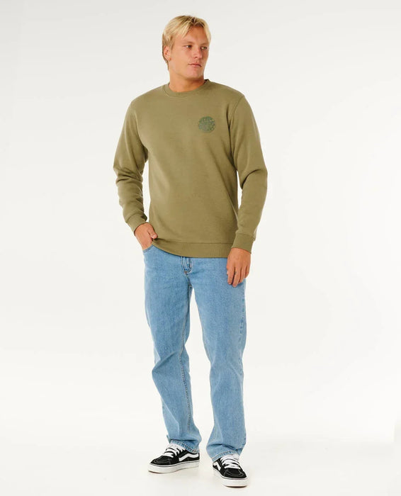 Rip Curl green crew neck sweatshirt with logo, surf clothing, worn by man in jeans and sneakers
