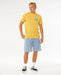 Rip Curl yellow ochre t-shirt with wetsuit logo, worn with denim shorts, surf casual style