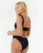 Rip Curl black one-piece swimsuit with cut-out back, worn by female model, watersports swimwear