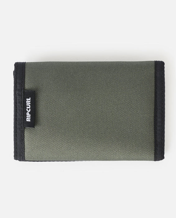 Green wallet with black trim and Rip Curl logo on a white background
