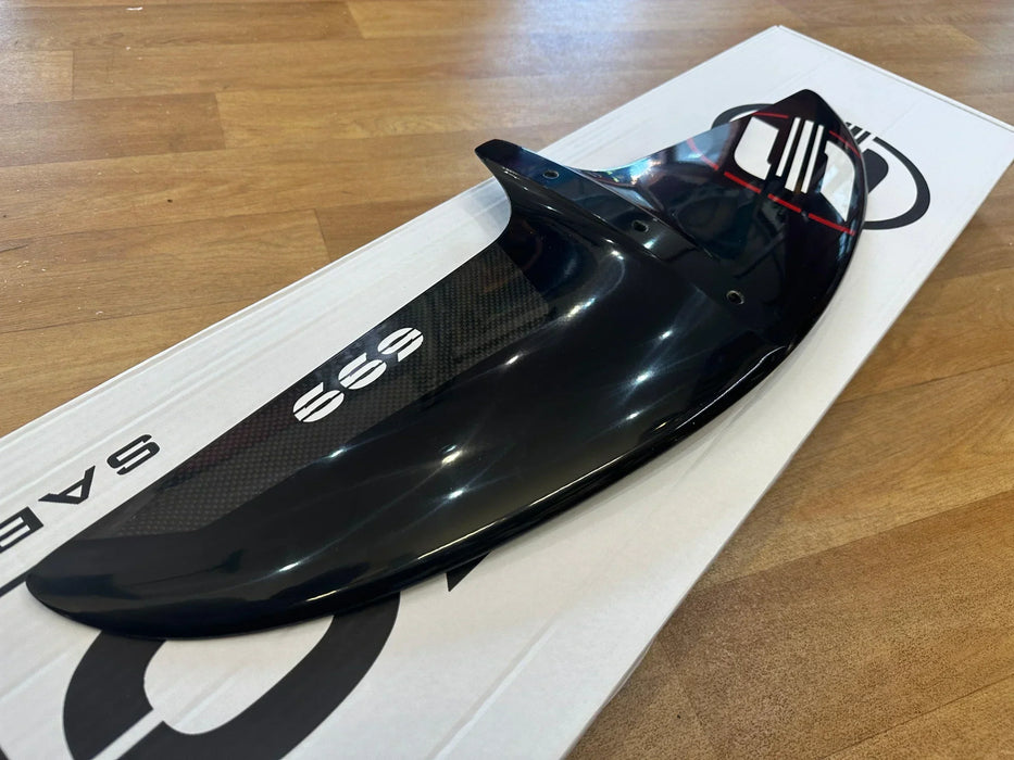 Sabfoil hydrofoil front wing W699 carbon, glossy black, on white box on wood floor