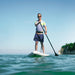 Paddler on a Sandbanks Ultimate Blue inflatable paddle board on calm water