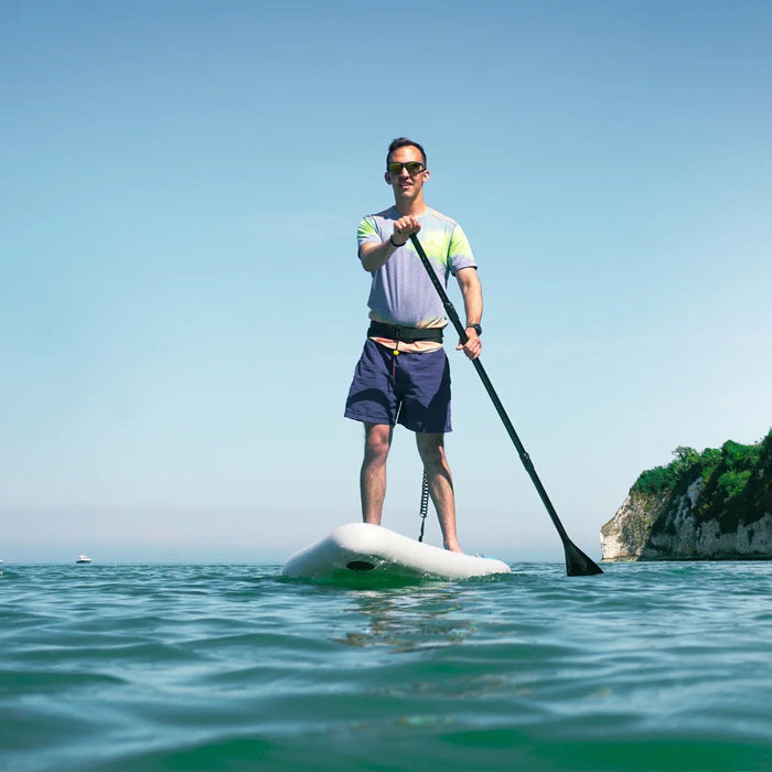 Paddler on a Sandbanks inflatable stand-up paddle board on calm water
