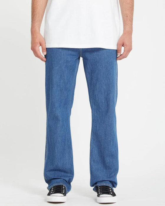 Volcom bold blue straight leg jeans worn by male model, surf clothing style