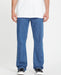 Volcom bold blue straight leg jeans worn by male model, surf clothing style