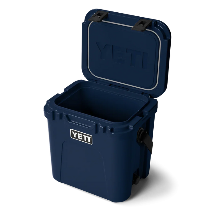 YETI Roadie 24 navy blue hard cooler with open lid, ideal for watersports or outdoor use